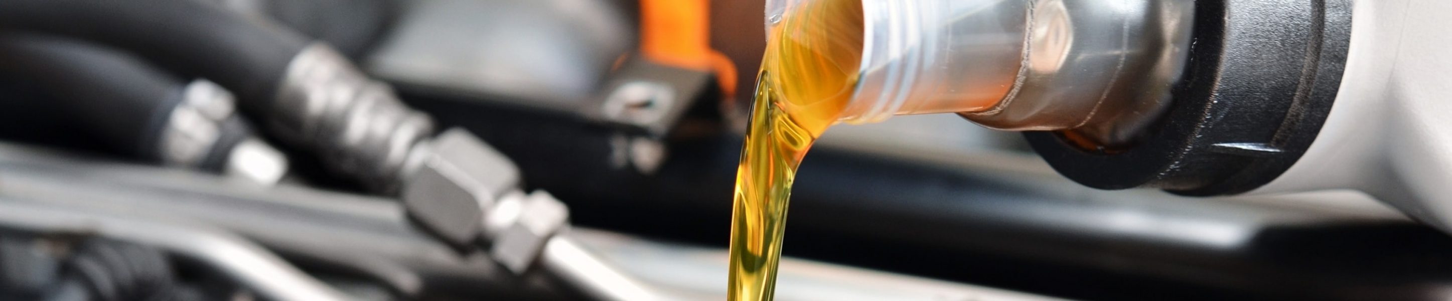 Oil being poured into car engine