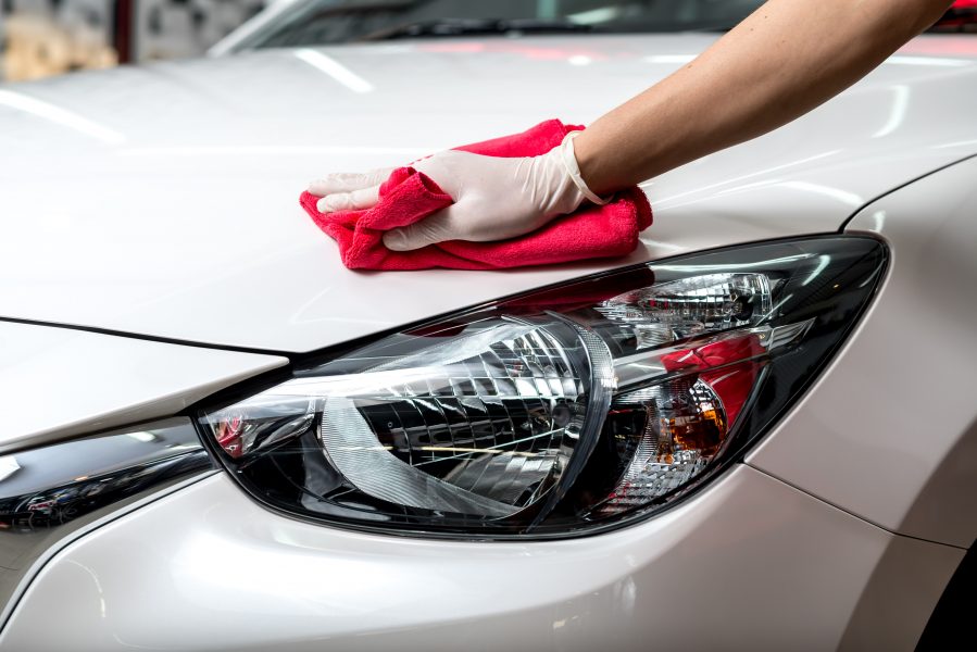 Person cleaning white car